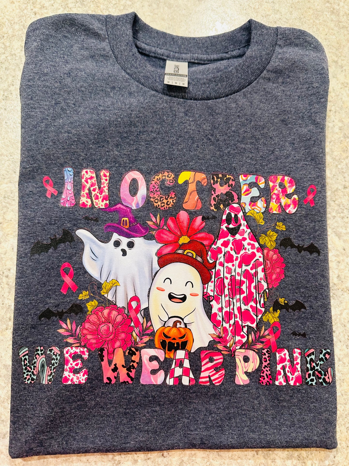 3 GHOST wearing pink graphic tee